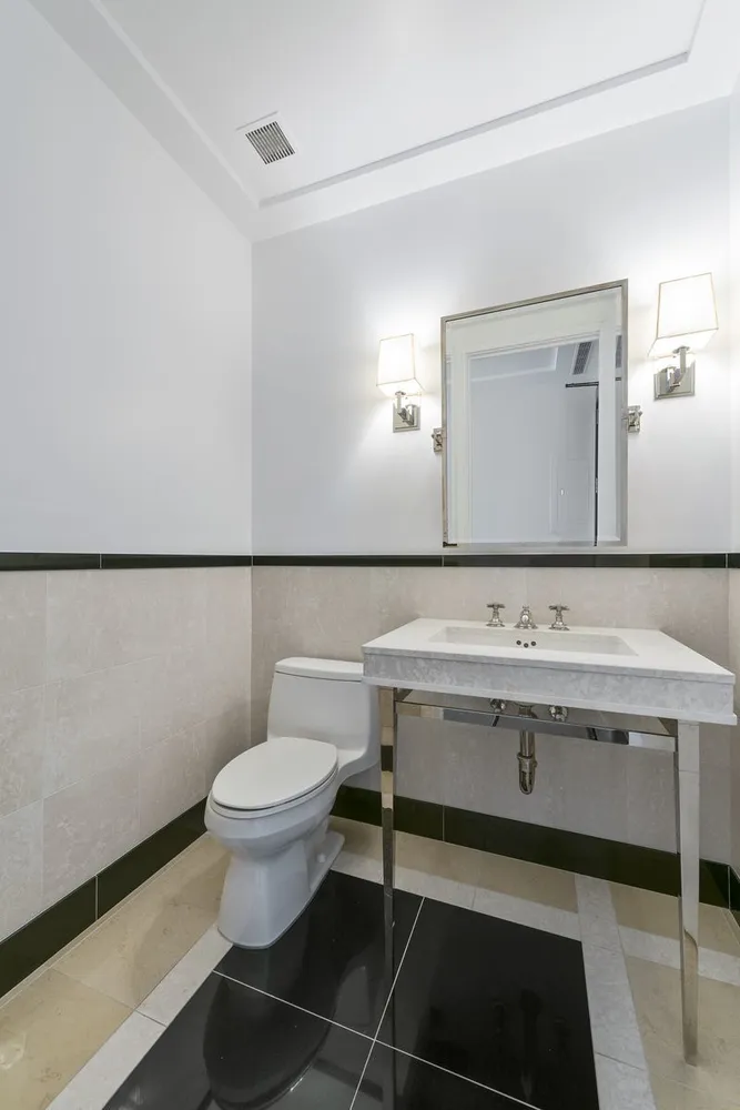 a bathroom with a sink a toilet and mirror
