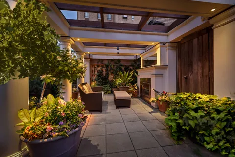 a view of a porch with dining table and chairs