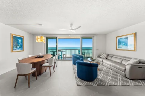 a living room with furniture a large window and a table