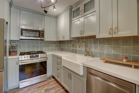 a kitchen with cabinets appliances and a sink