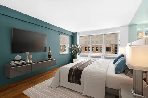 a bedroom with a bed and a flat screen tv