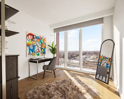 a living room filled with furniture and a painting on the wall