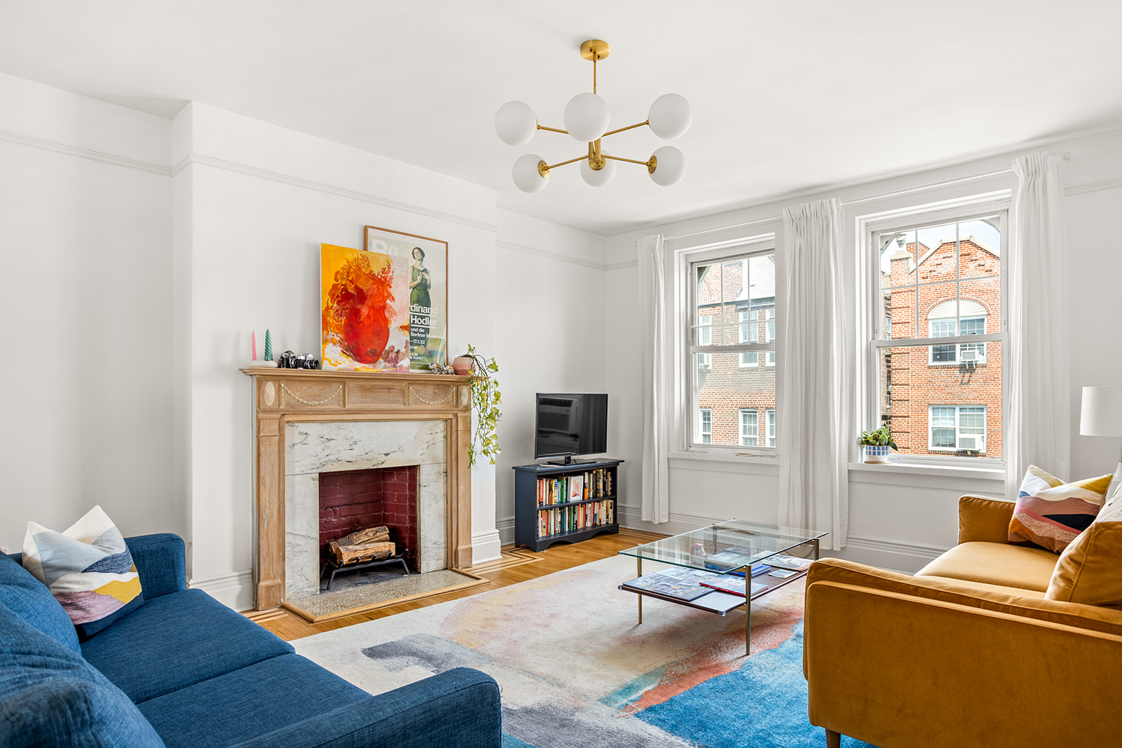 35-14 77th Street, Unit 52 Queens, NY 11372 - Photo 2 of 11 a living room with furniture fireplace and flat screen tv