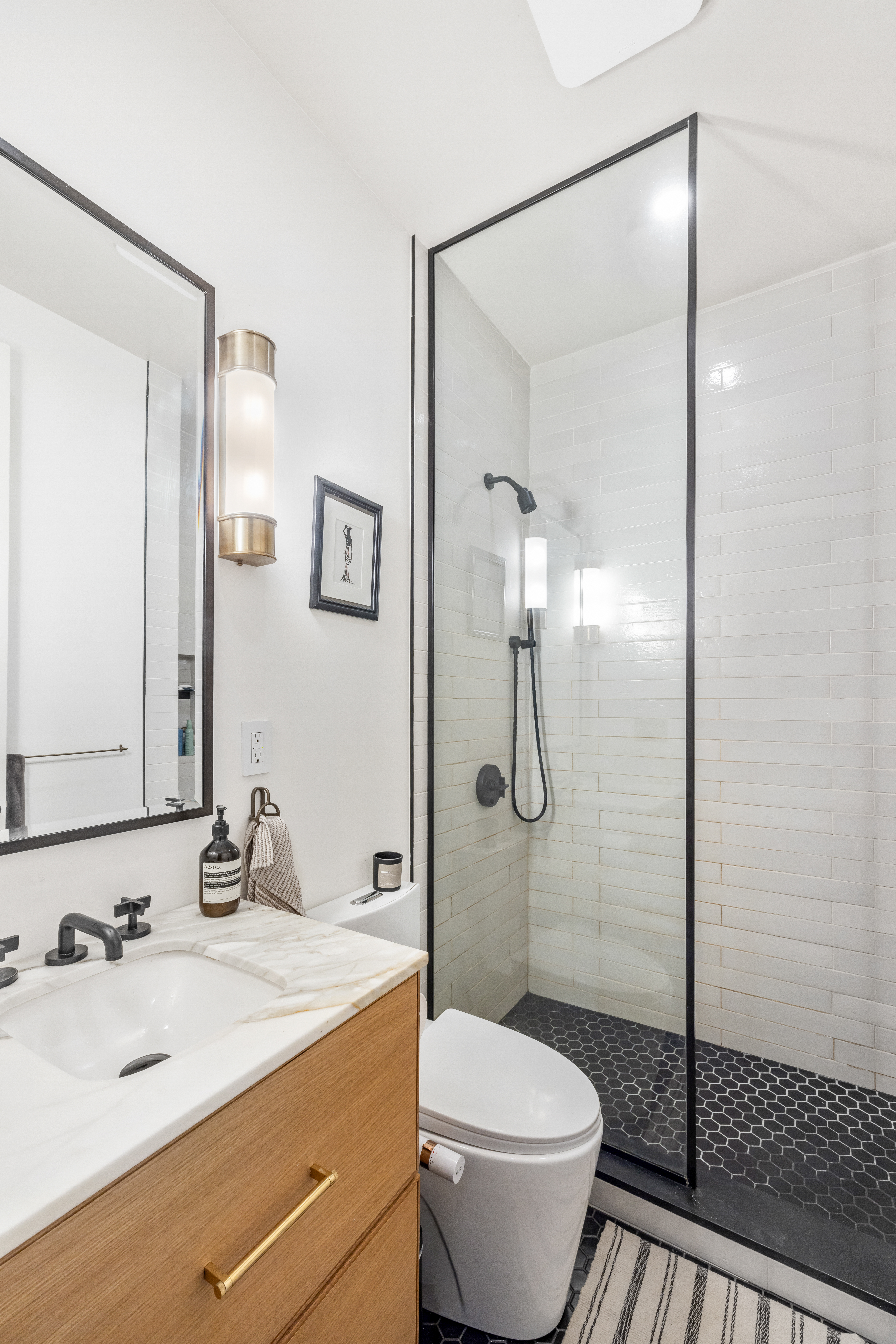 735 Dean Street, Unit 2B Brooklyn, NY 11238 - Photo 8 of 11 a bathroom with a sink toilet and shower