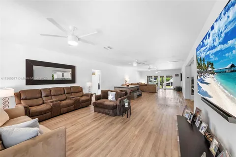 a living room with furniture or couch and a large window