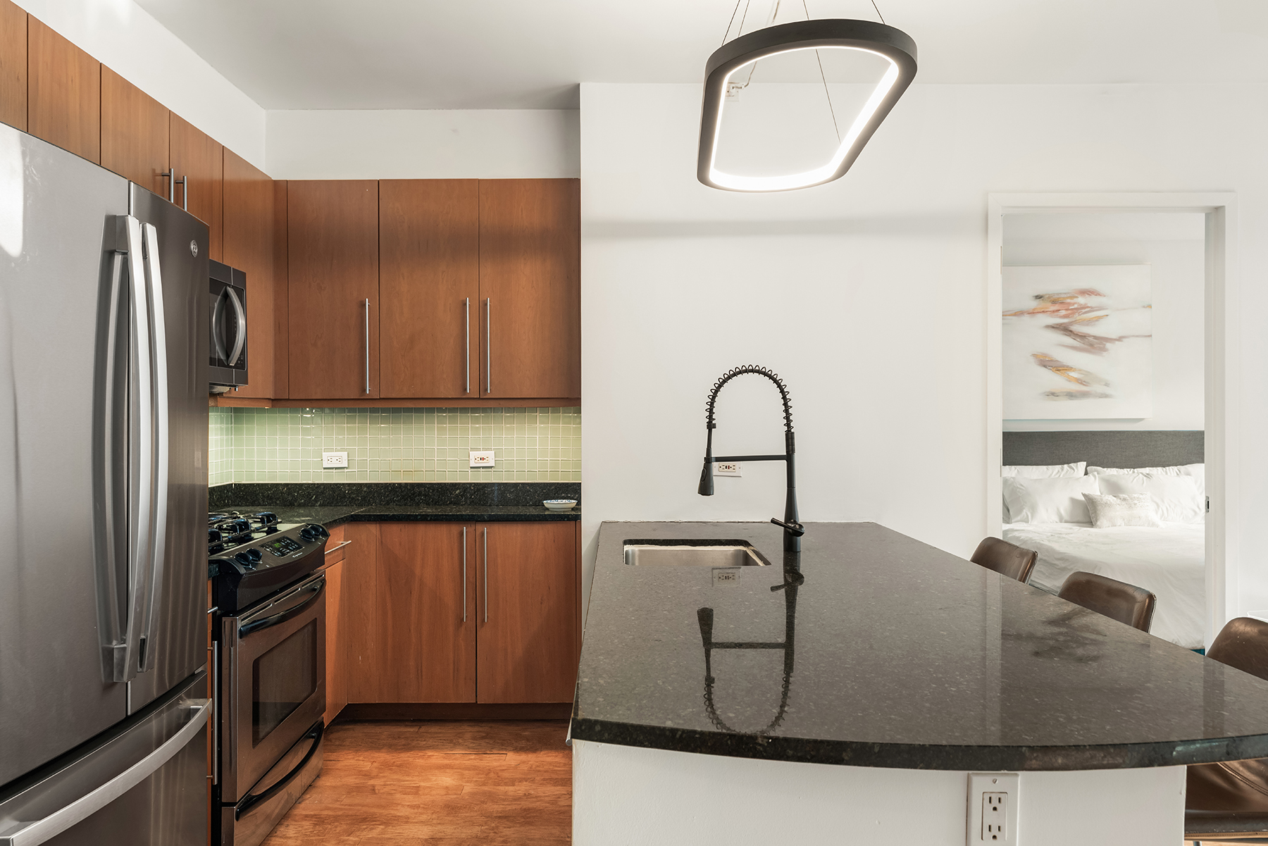 242 East 25th Street, Unit 3A Manhattan, NY 10010 - Photo 2 of 9 a kitchen with granite countertop a sink a stove and refrigerator