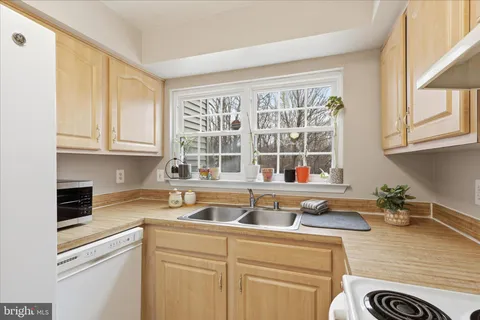 a bedroom with bed and a large window