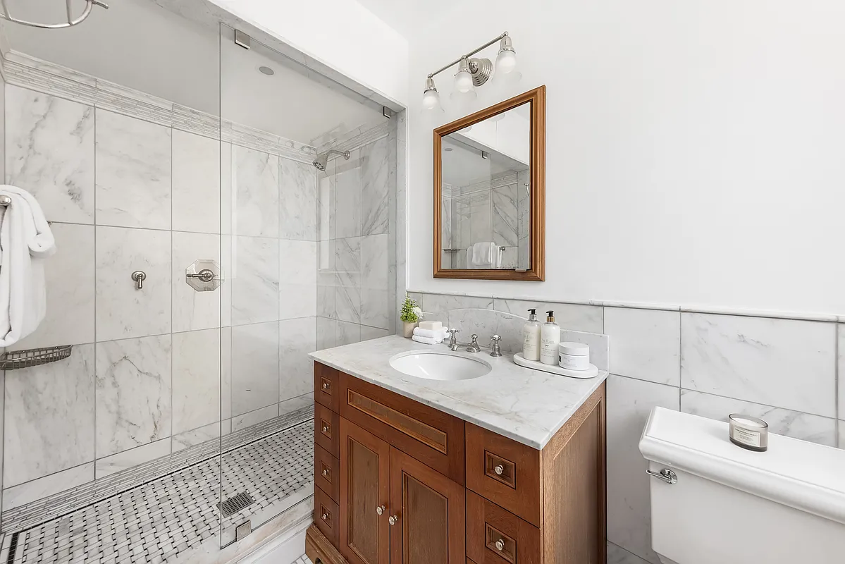 180 East 79th Street, Unit 14B Manhattan, NY 10075 - Photo 16 of 18 a bathroom with a sink toilet and shower