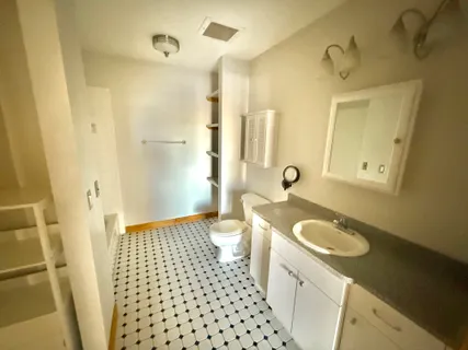 a view of a kitchen with refrigerator and windows