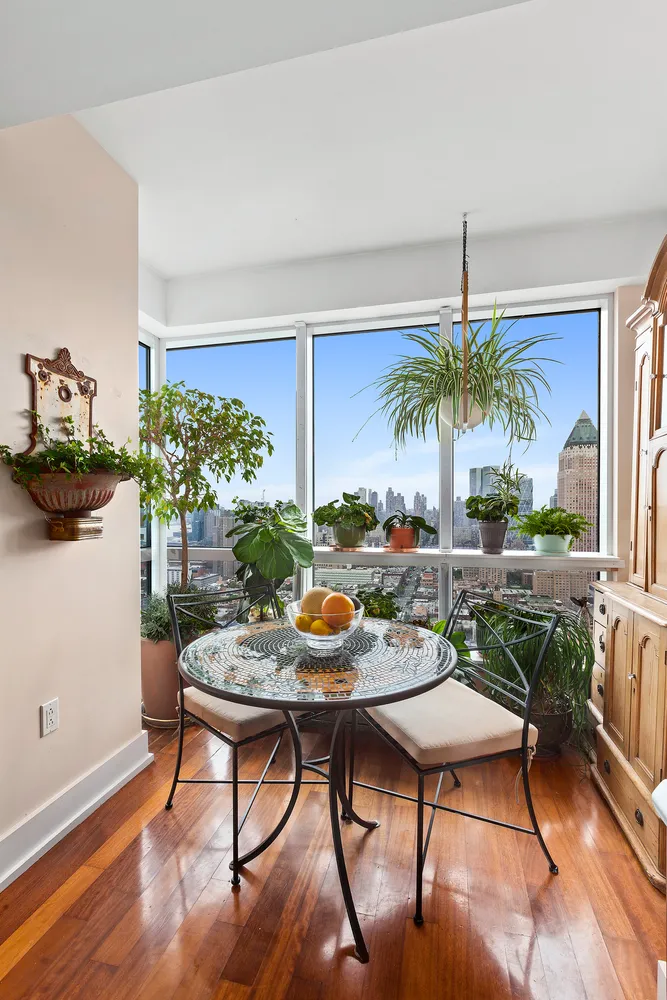 a view of a dining room with furniture window and wooden floor