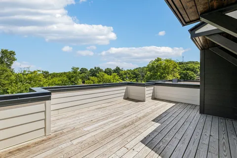 a view of balcony with wooden floor