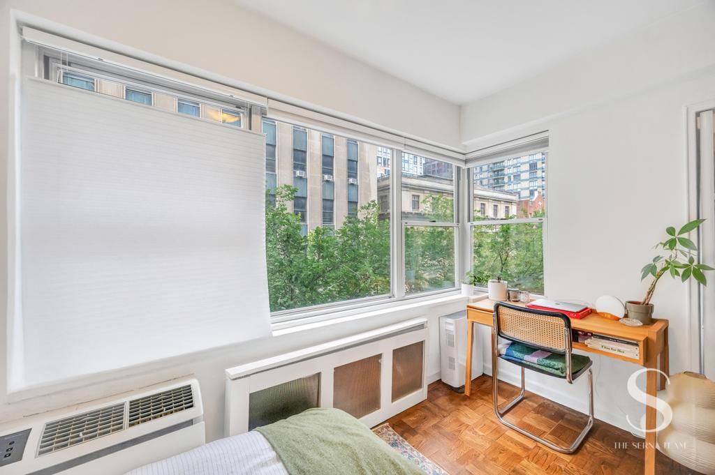 7 Lexington Avenue, Unit 5E Manhattan, NY 10010 - Photo 19 of 27 a living room with furniture and a window