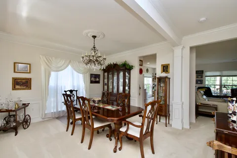 a view of a dining room with furniture and chandelier