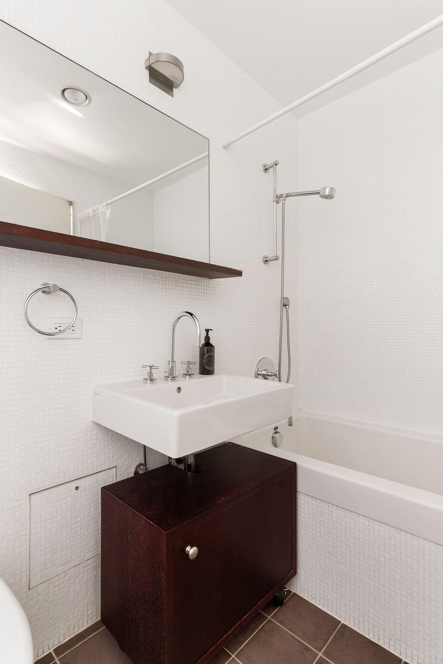 21 Astor Place, Unit 9E Manhattan, NY 10003 - Photo 8 of 10 a bathroom with a sink and a mirror