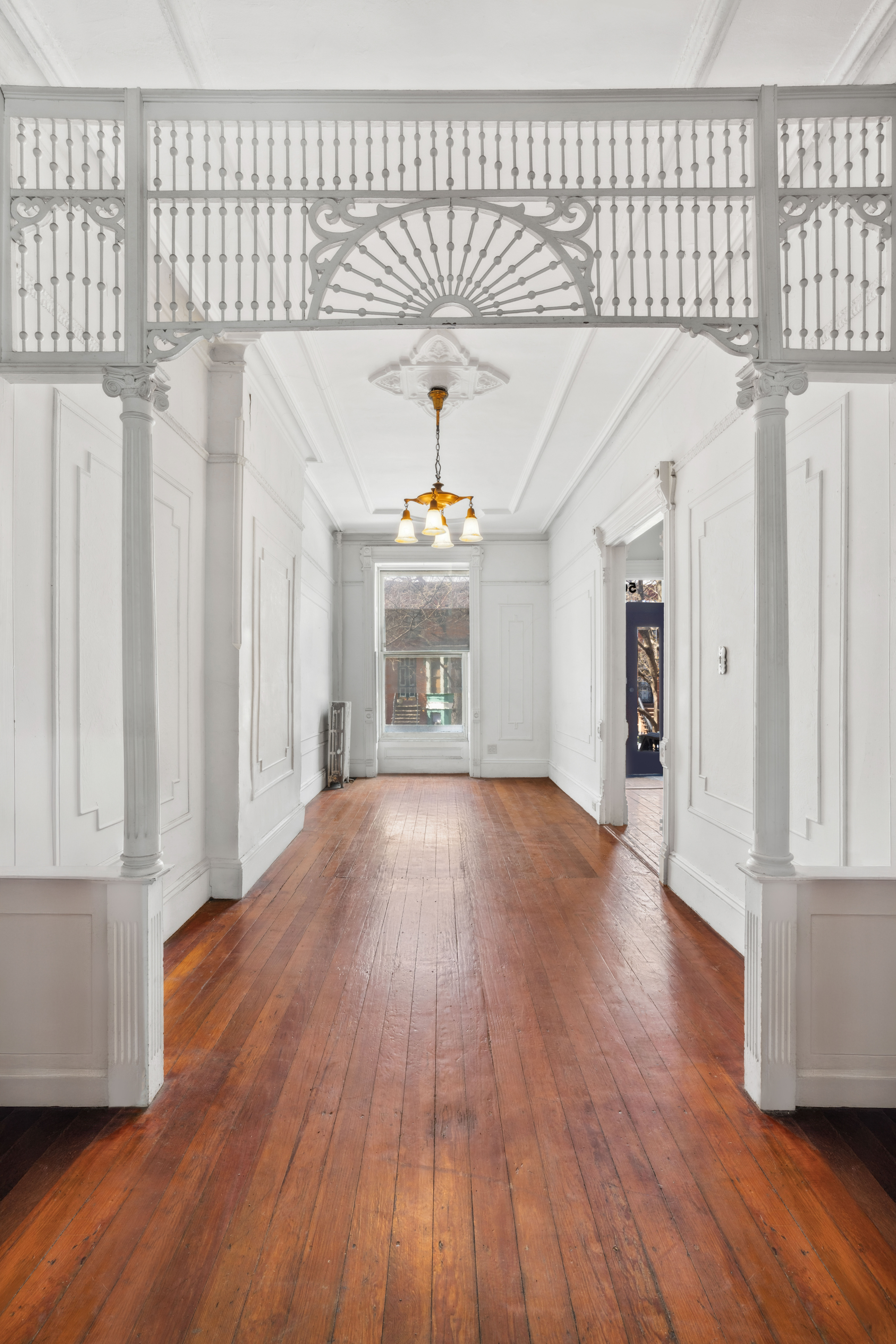 509 6th Avenue Brooklyn, NY 11215 - Photo 4 of 20 a view of a hallway with wooden floor and staircase