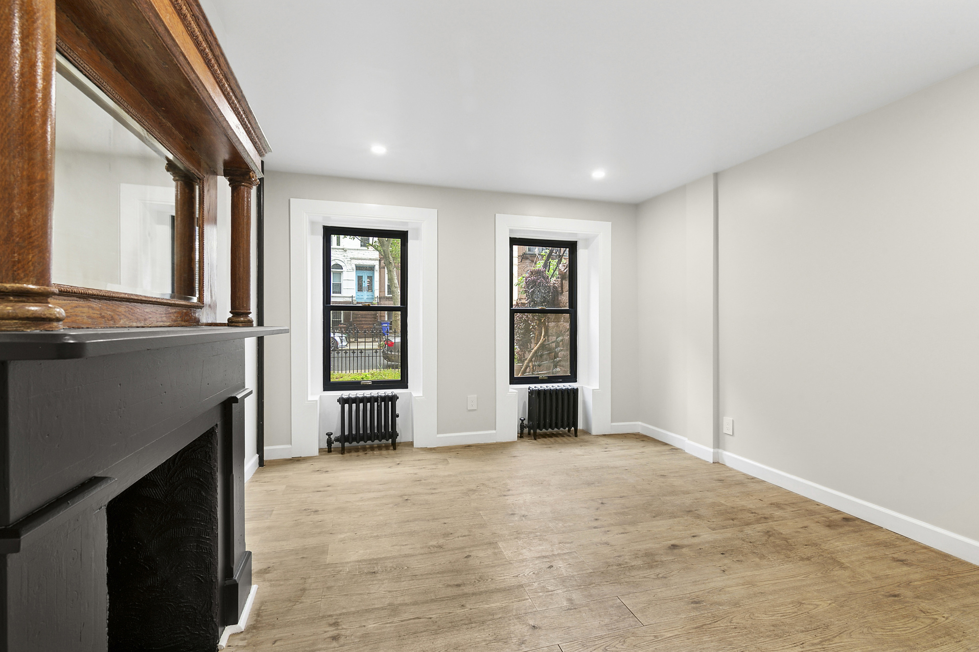 555 MacDonough Street, Unit 1 Brooklyn, NY 11233 - Photo 6 of 7 a view of an empty room with a fireplace and a window