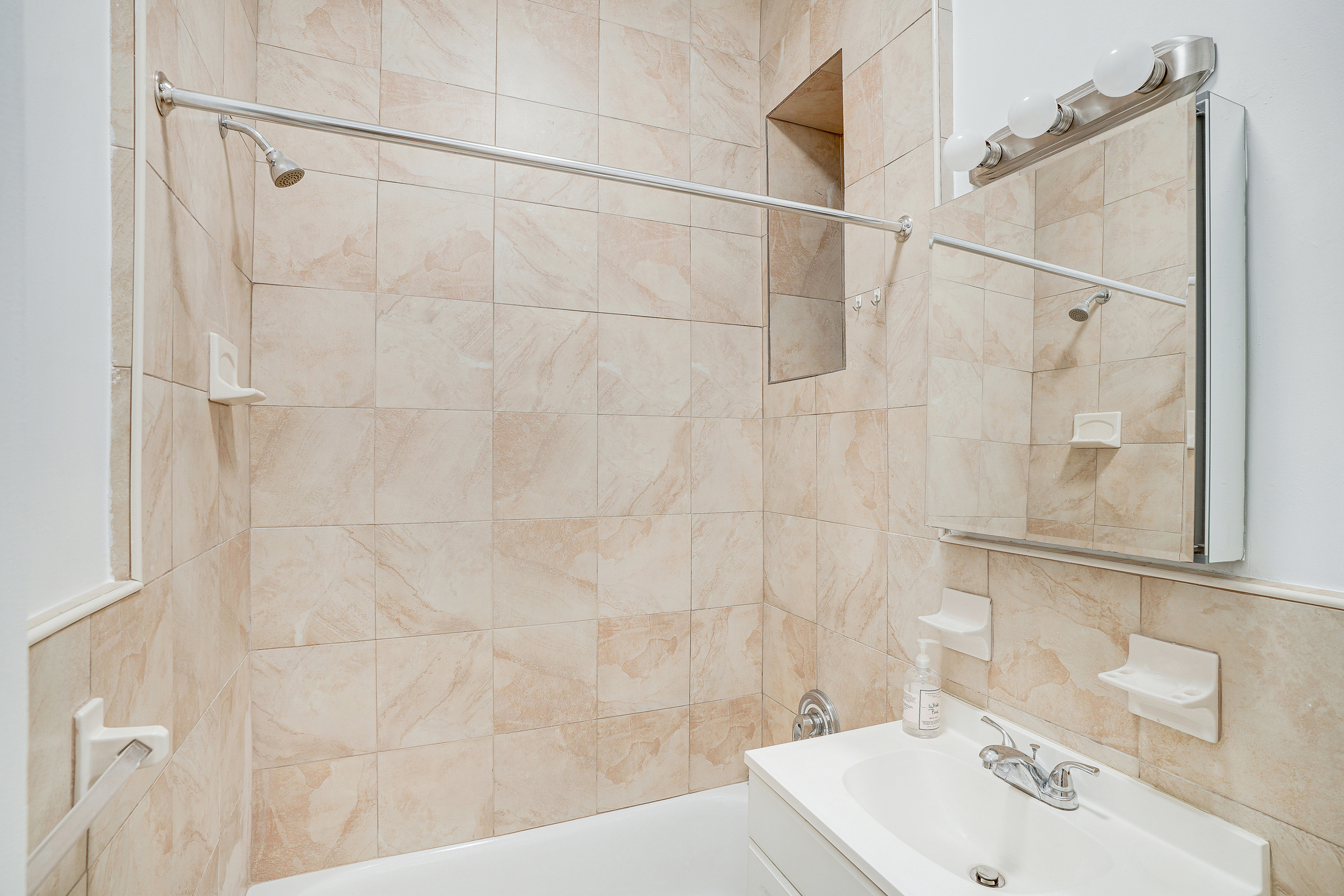 433 East 82nd Street, Unit 1A Manhattan, NY 10028 - Photo 6 of 6 a bathroom with a sink shower and a mirror