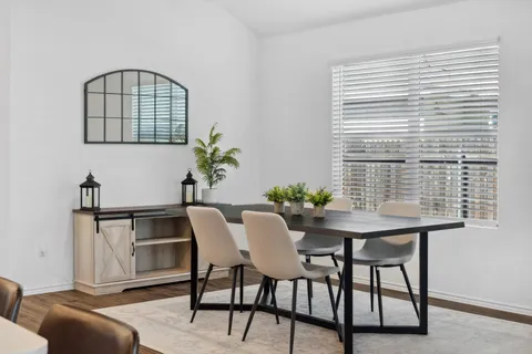 a view of a livingroom with furniture and a window