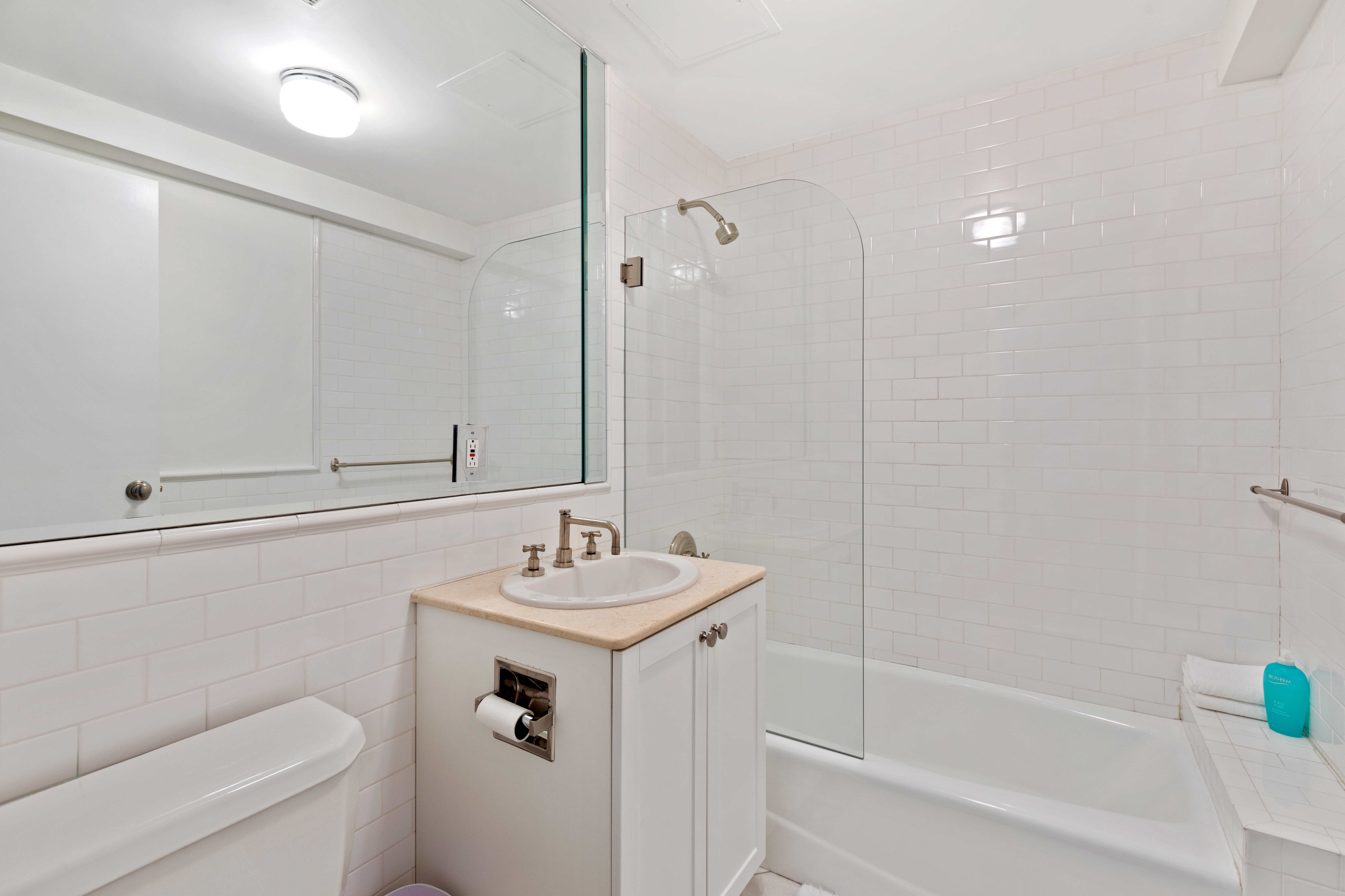 79 Laight Street, Unit 5H Manhattan, NY 10013 - Photo 11 of 13 a bathroom with a sink a toilet and shower
