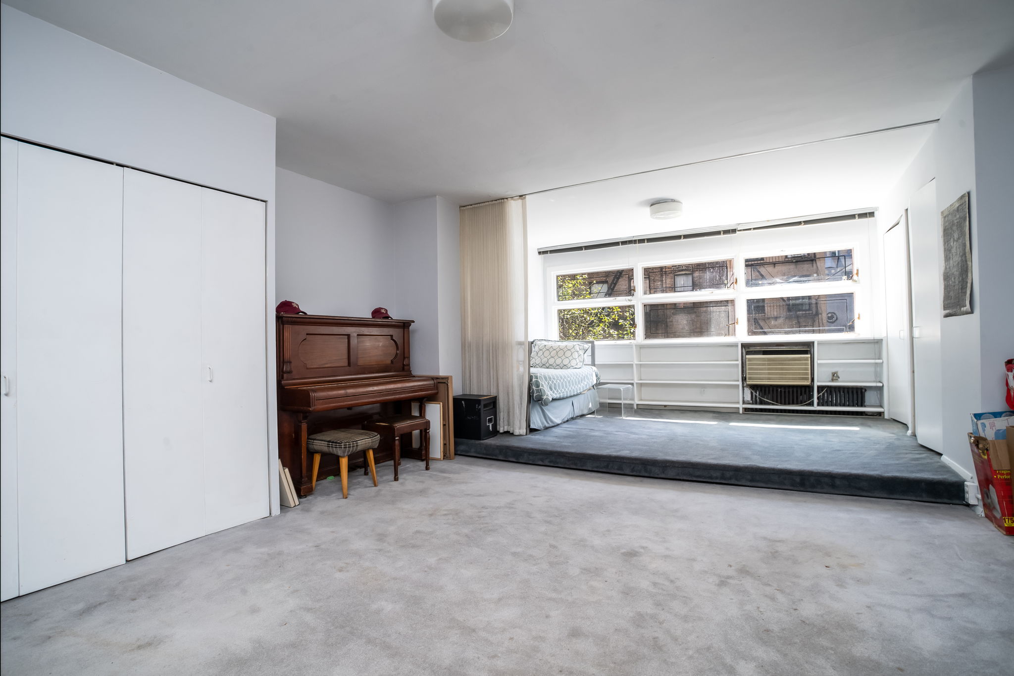 206 East 30th Street Manhattan, NY 10016 - Photo 12 of 21 a living room with furniture and a piano