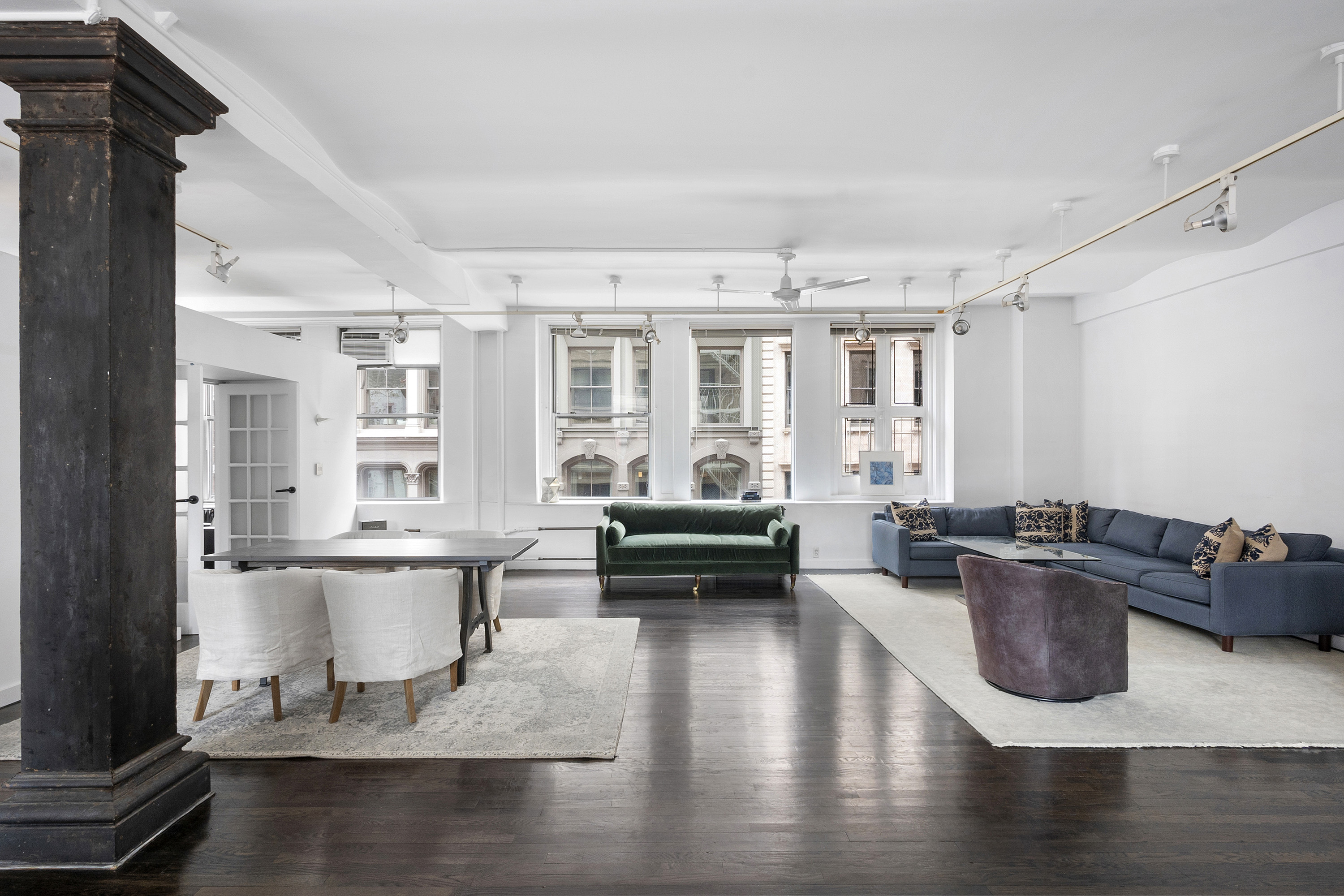a living room with furniture window and wooden floor