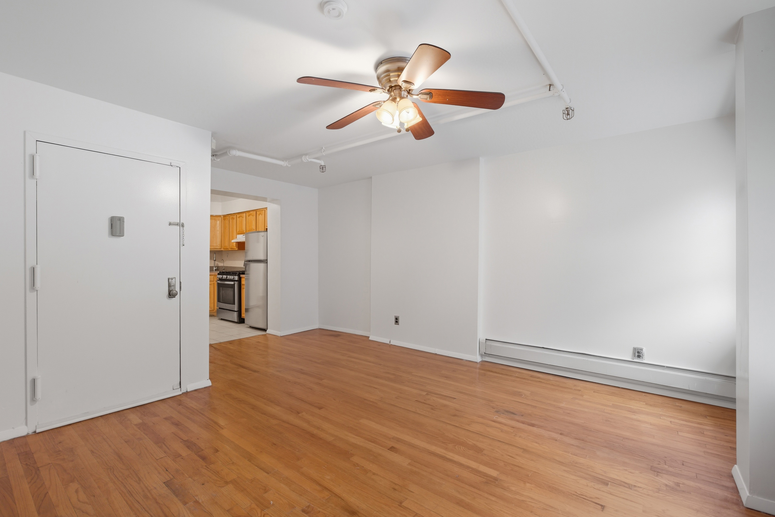 420 East 117th Street, Unit 1 Manhattan, NY 10035 - Photo 3 of 9 an empty room with closet and windows