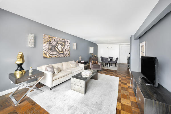 77 7th Avenue, Unit 9E Manhattan, NY 10011 - Photo 1 of 9 a living room with furniture and a flat screen tv
