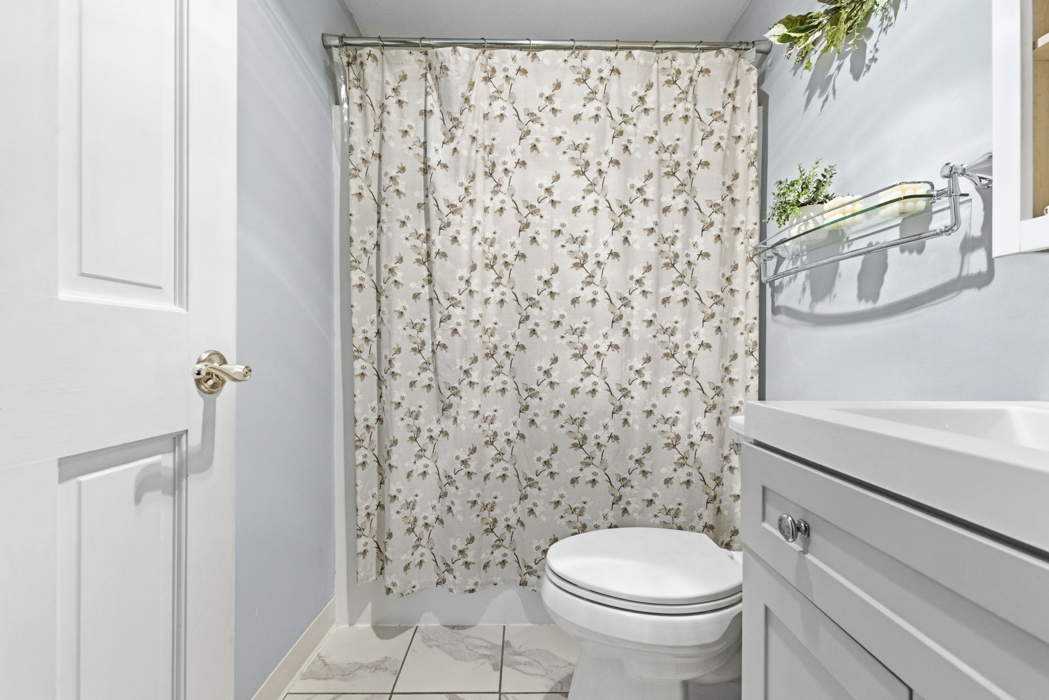 61 Wright Street, Unit 102 Stoneham, MA 02180 - Photo 19 of 26 a bathroom with a toilet and a shower curtain