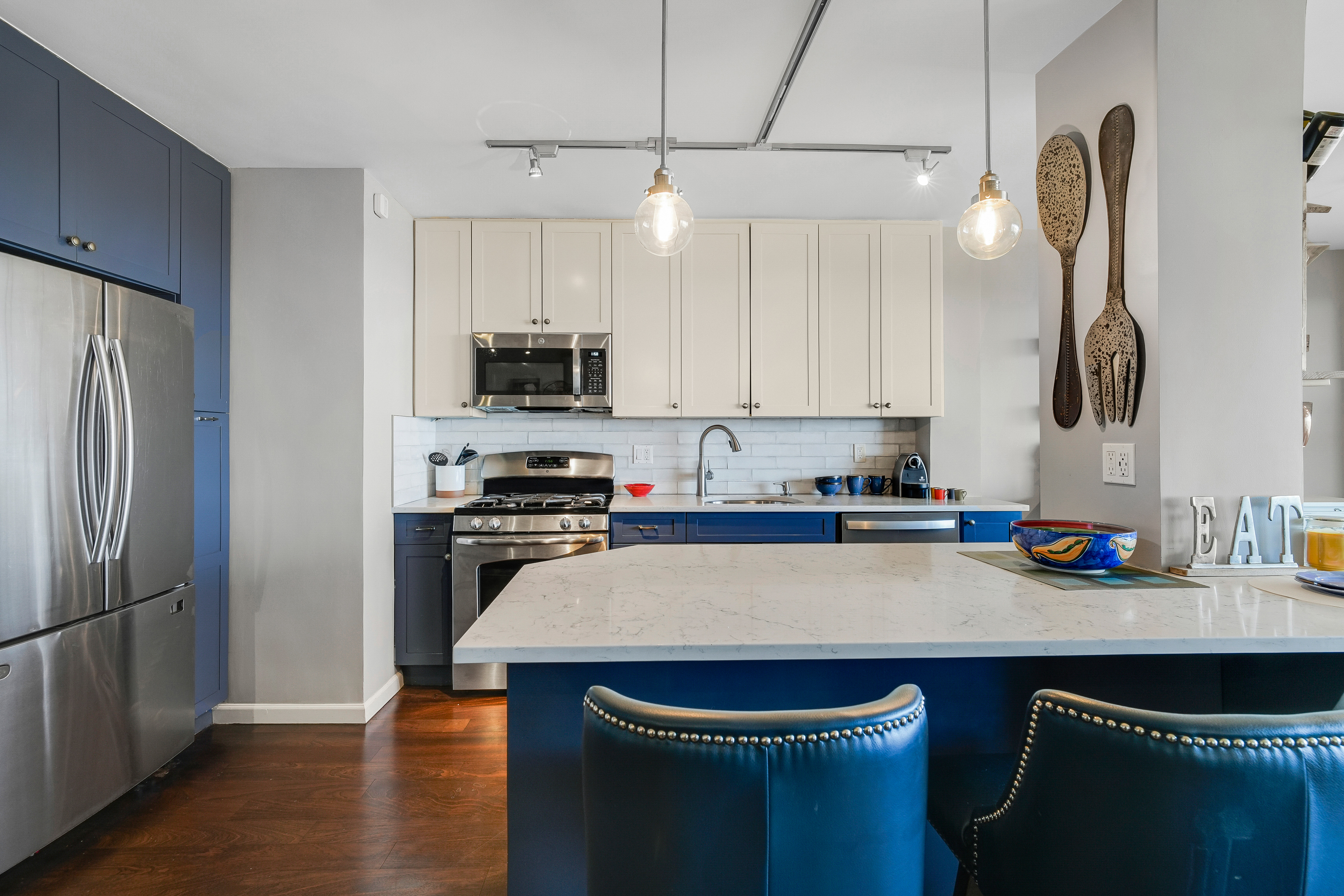 5900 Arlington Avenue, Unit 17W Bronx, NY 10471 - Photo 4 of 14 a kitchen with kitchen island a counter space a sink a refrigerator and cabinets