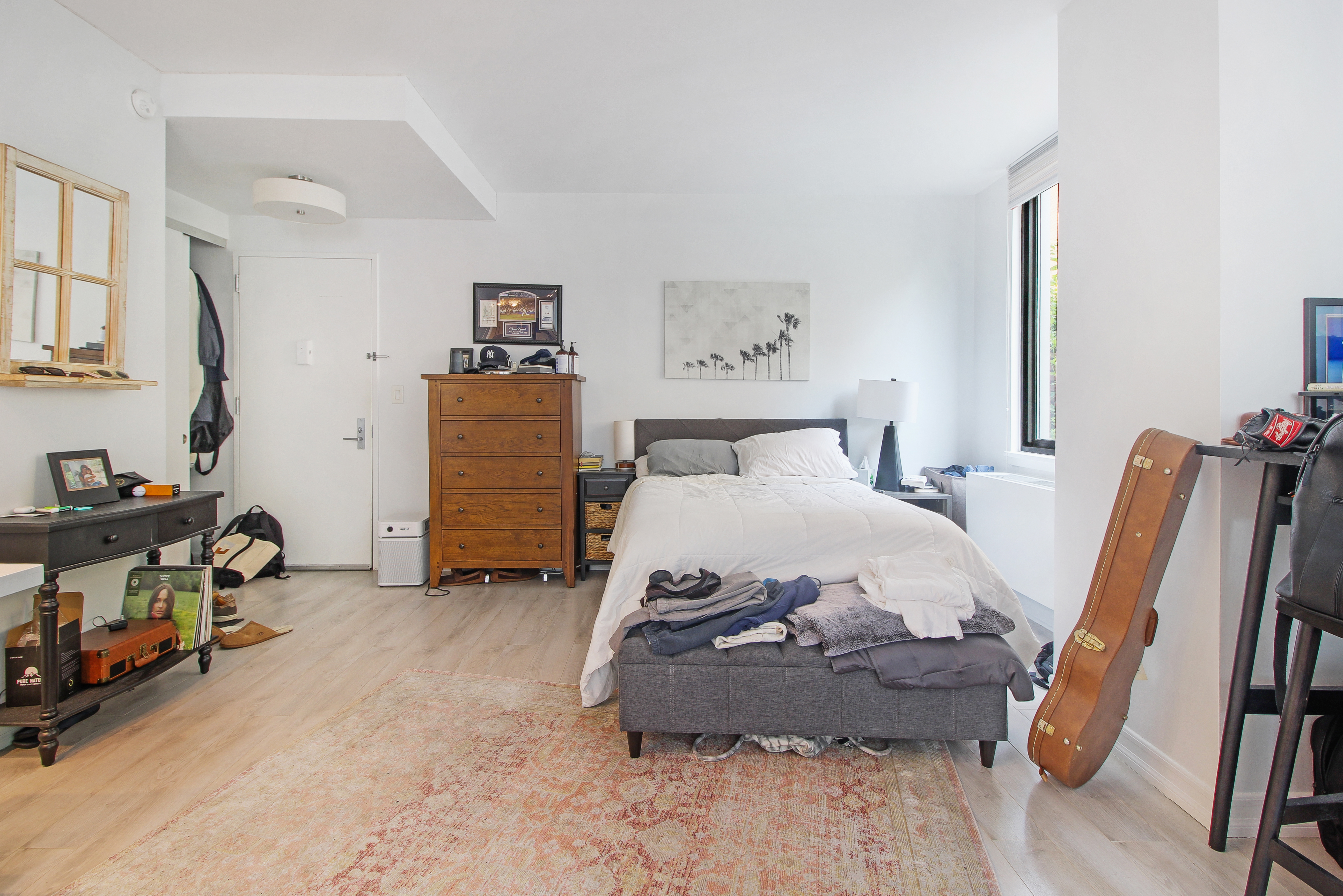 199 Bowery, Unit 2B Manhattan, NY 10002 - Photo 2 of 12 a room with a bed and a chair