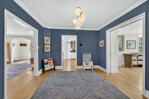 a view of a livingroom with wooden floor and a ceiling fan