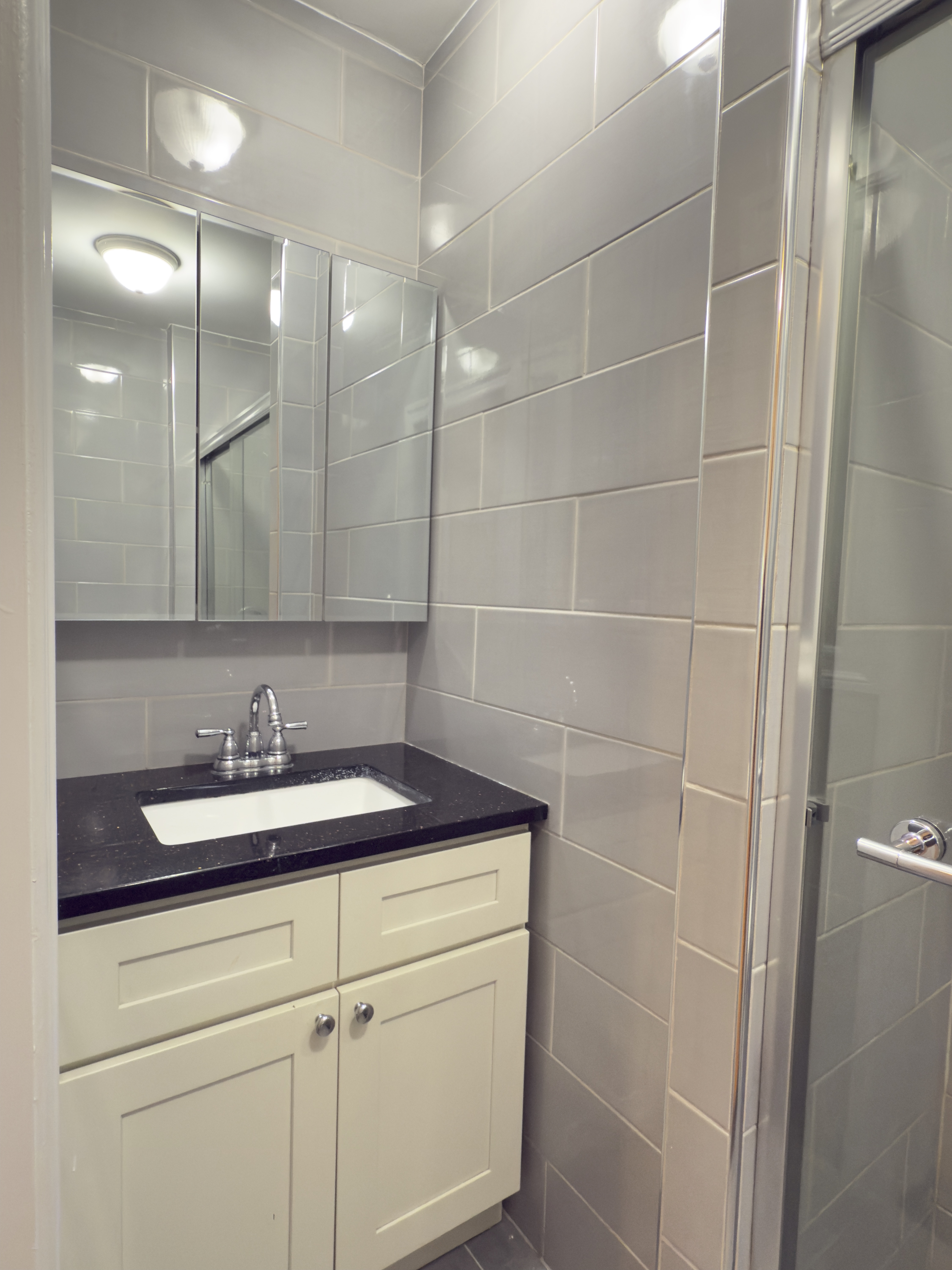 398 3rd Avenue, Unit 2C Manhattan, NY 10016 - Photo 5 of 6 a bathroom with a sink and a mirror