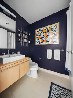 a bathroom with a sink a toilet and mirror