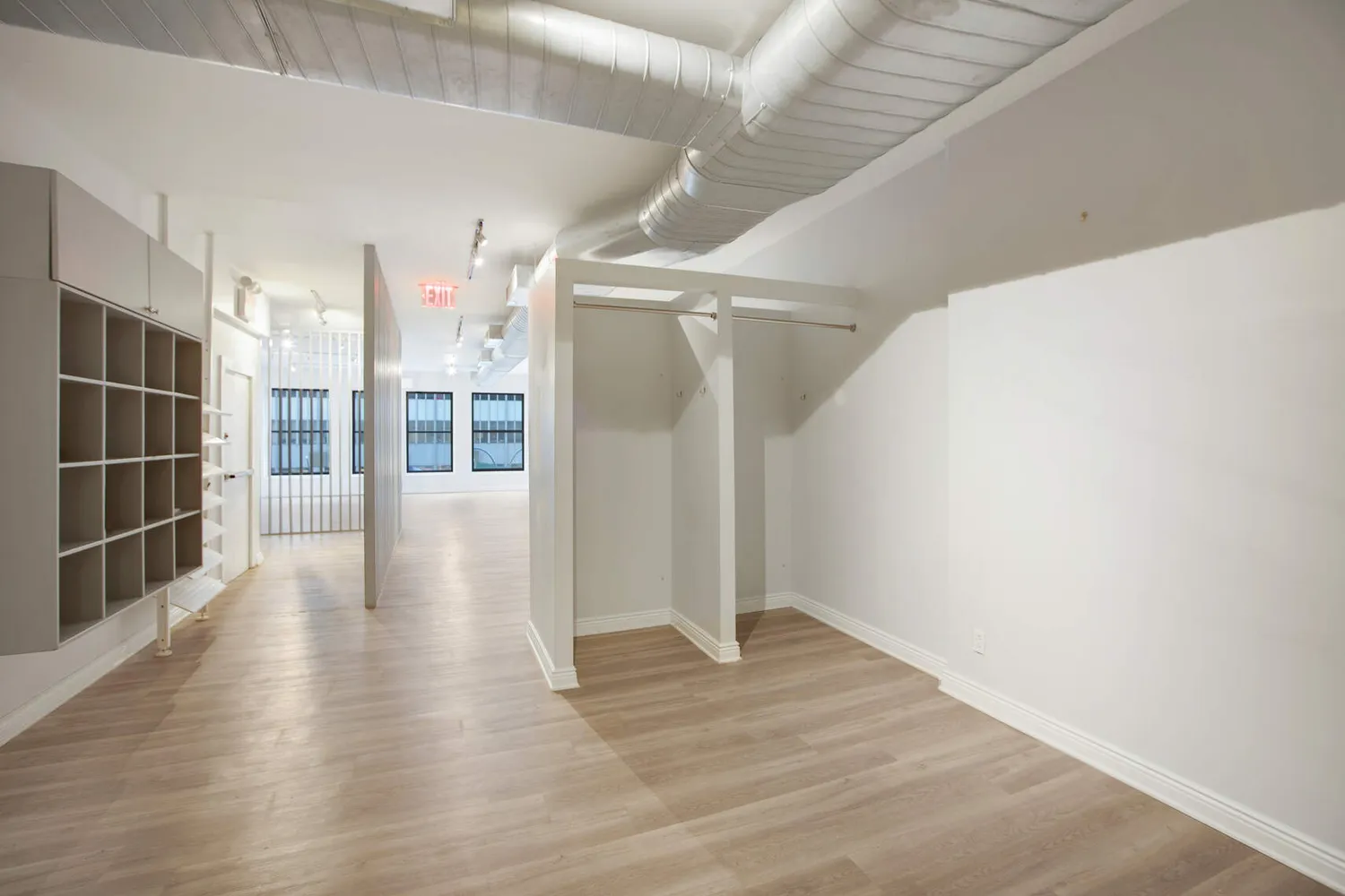 a view of a room with wooden floor and windows