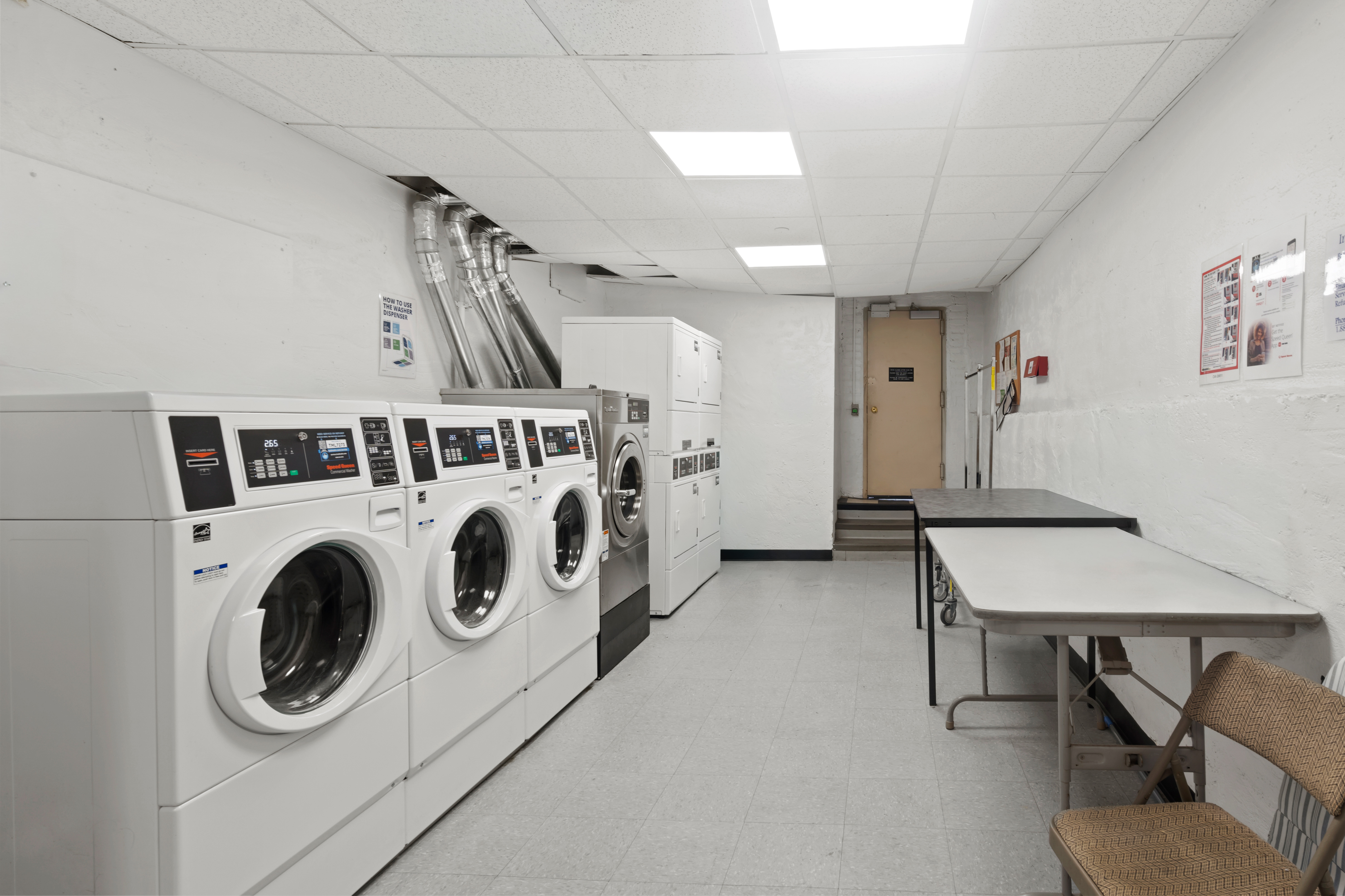 649 2nd Avenue, Unit 4G Manhattan, NY 10016 - Photo 11 of 12 a utility room with dryer washer and a view of living room