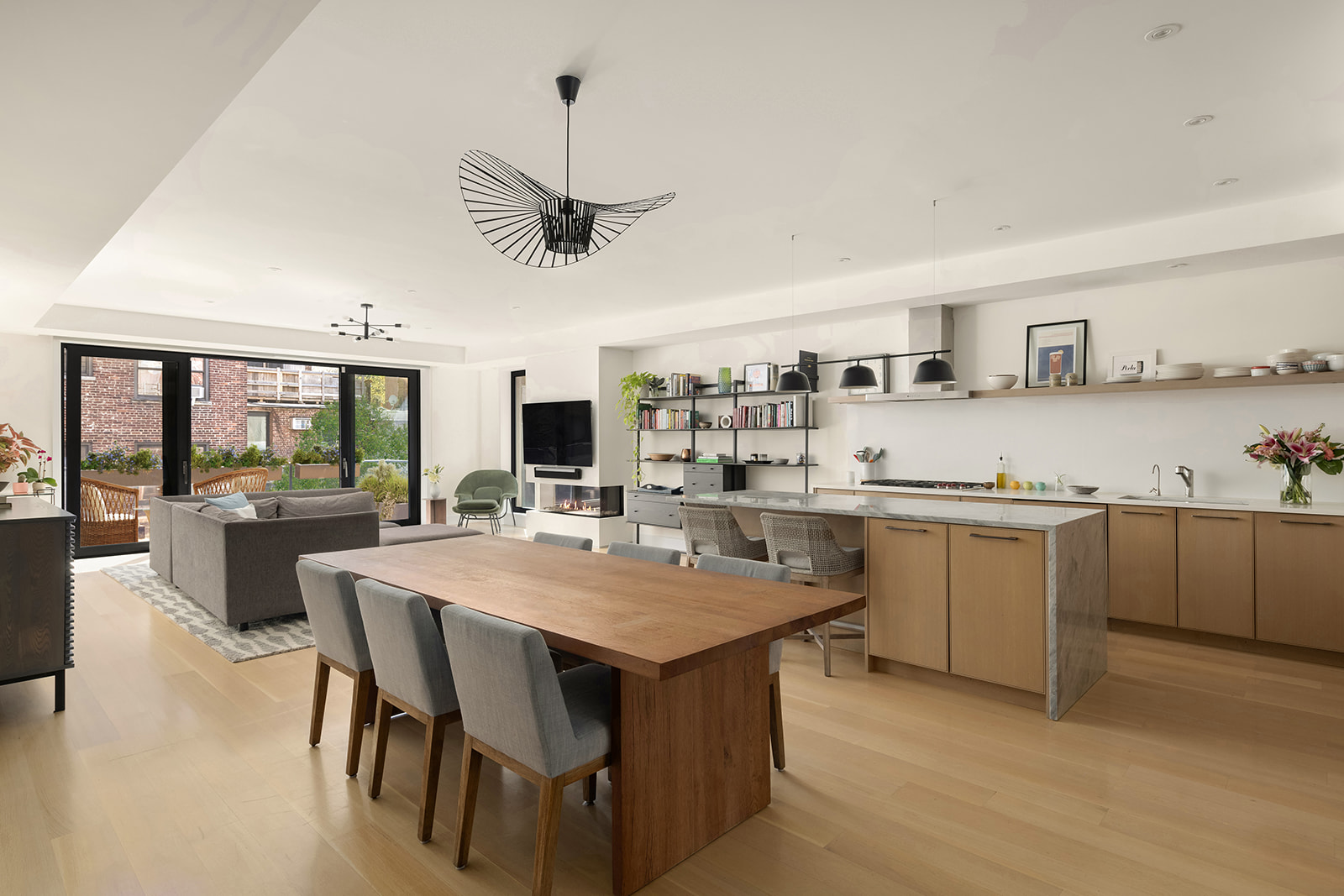 a large kitchen with a table and chairs