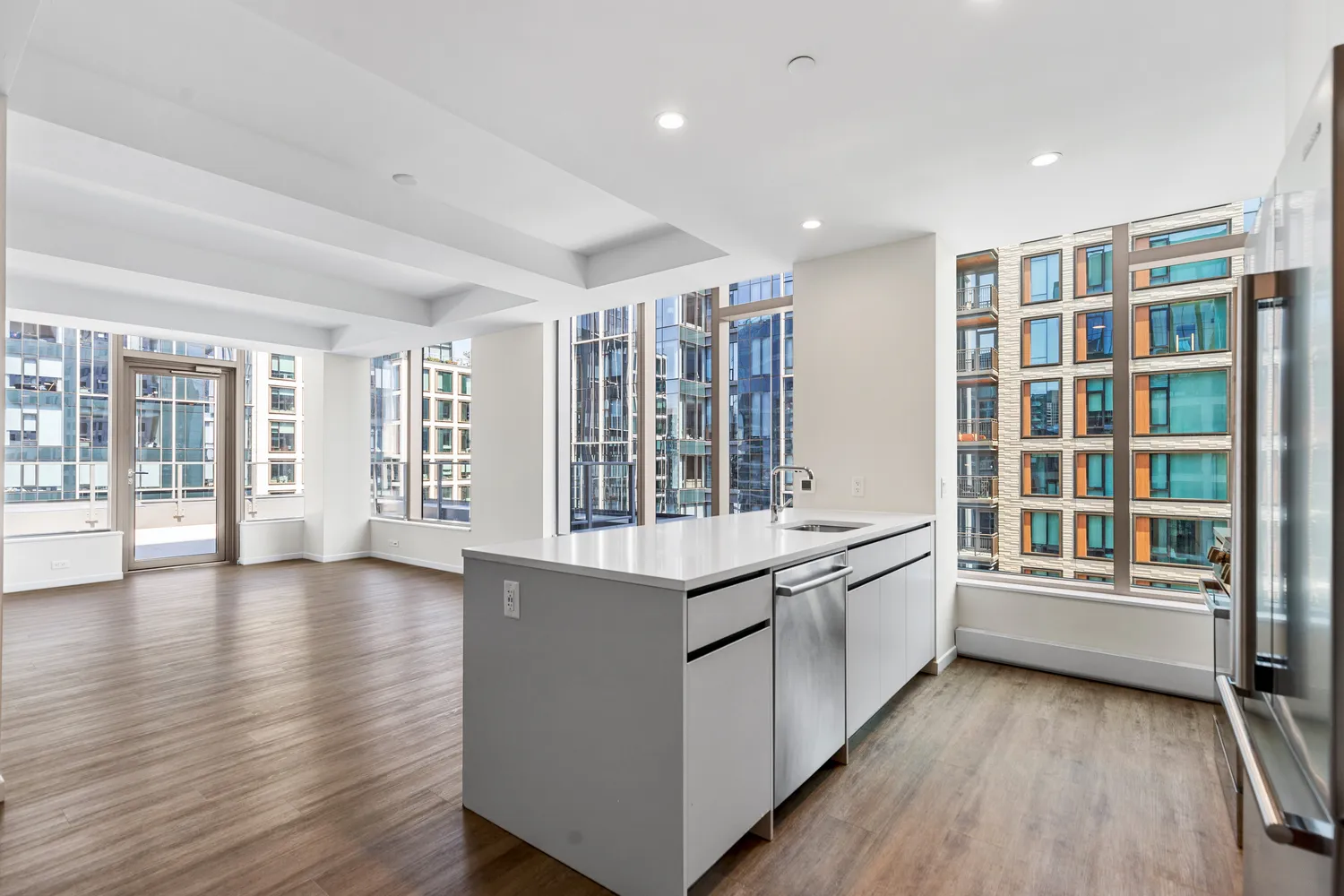 a large kitchen with a large counter top and stainless steel appliances