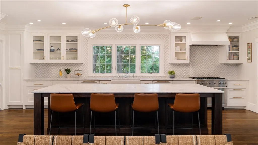 a kitchen with granite countertop a sink and a refrigerator