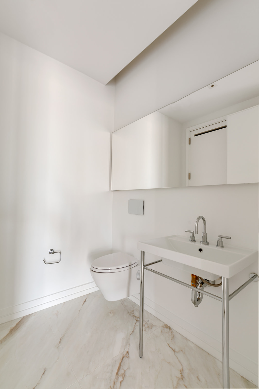 200 East 59th Street, Unit 11C Manhattan, NY 10022 - Photo 7 of 11 a bathroom with a sink toilet and vanity