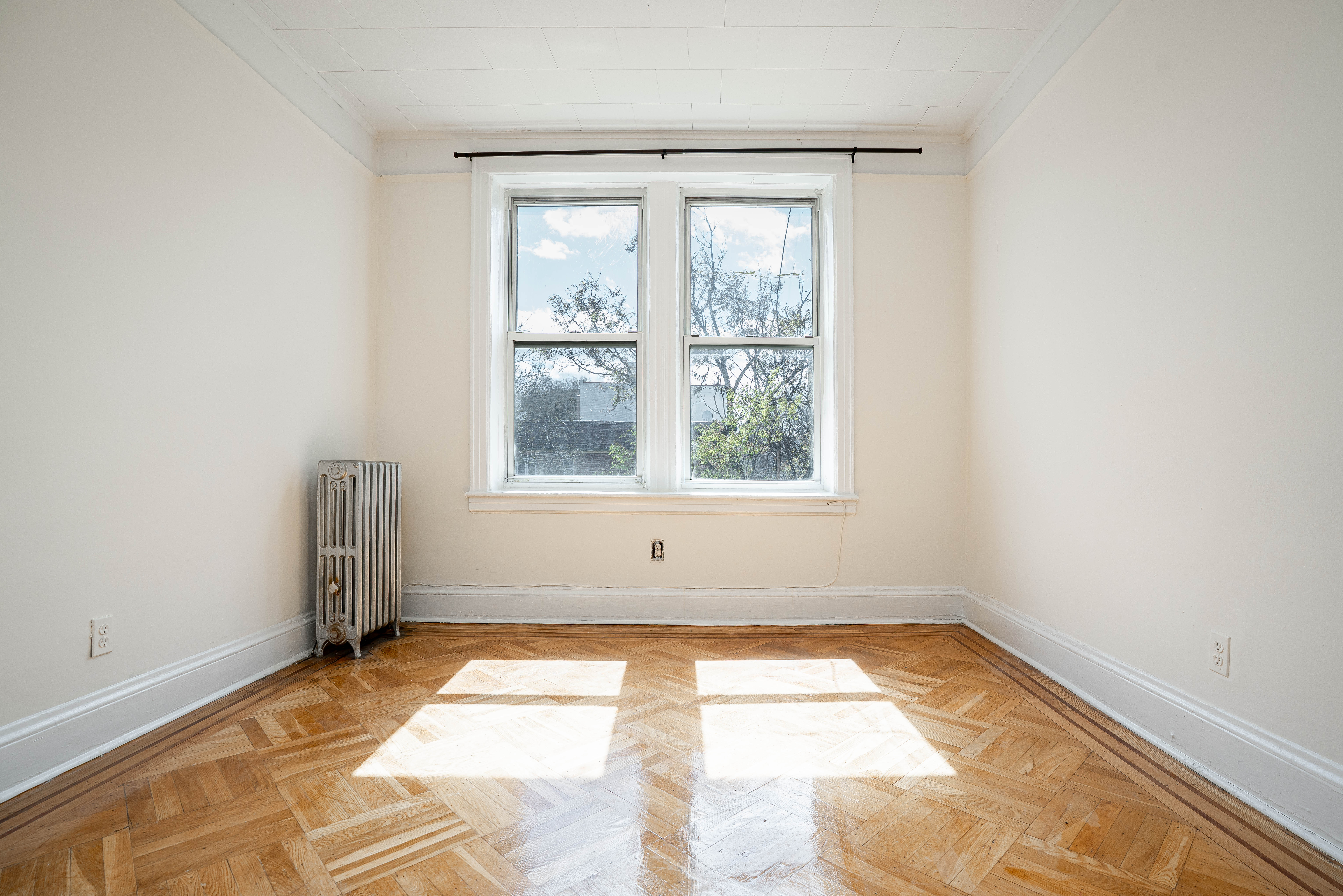 27-15 24th Avenue, Unit 2 Queens, NY 11105 - Photo 9 of 10 an empty room with a window
