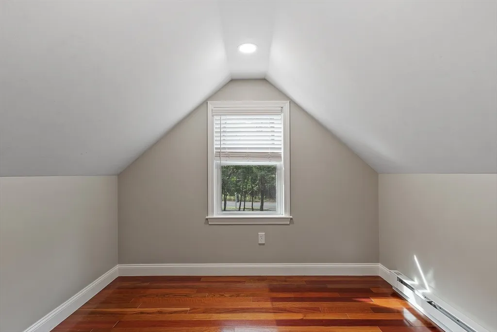 a view of a hallway with a window and a chandelier