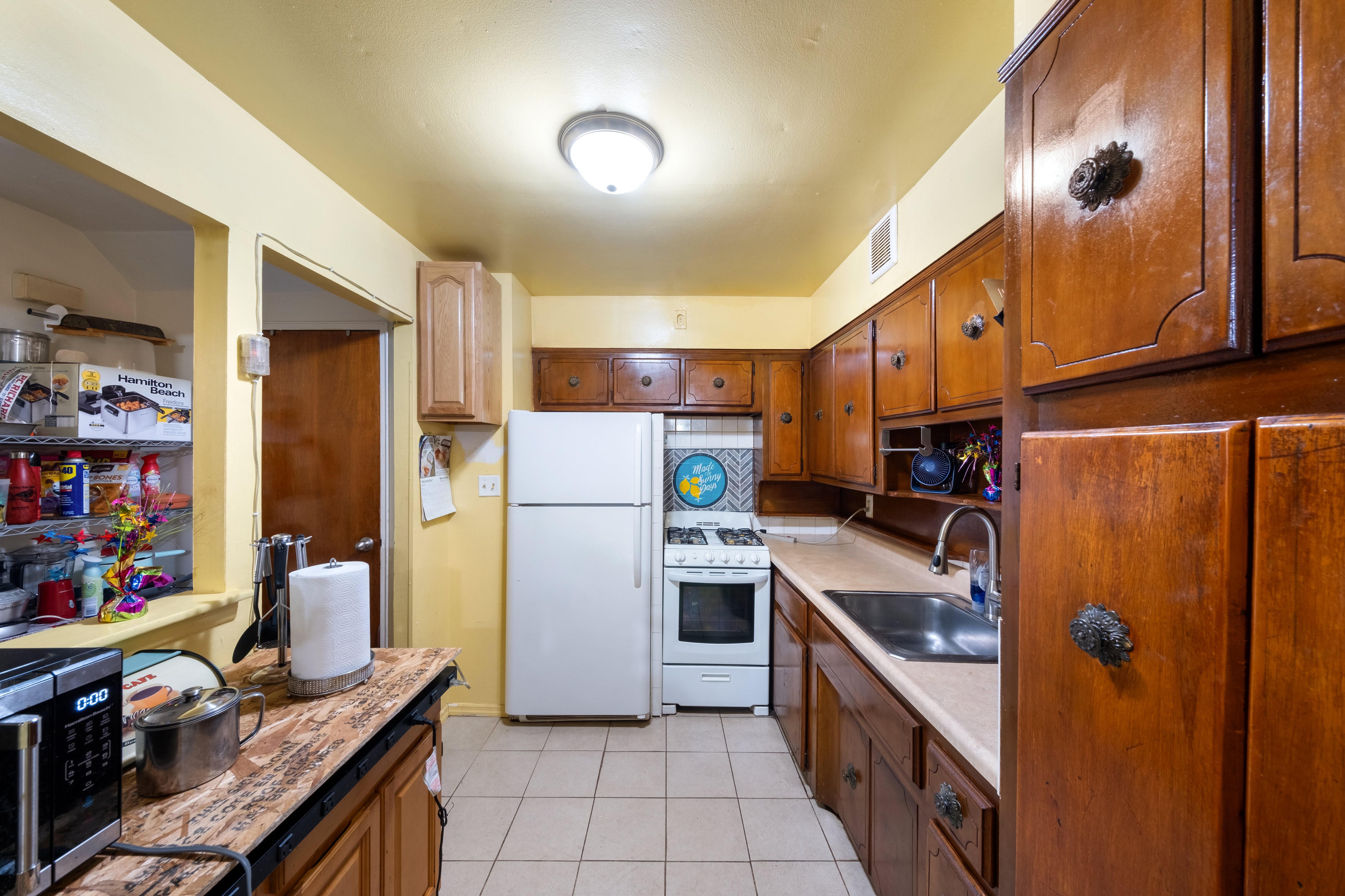 1464 East 84th Street Brooklyn, NY 11236 - Photo 9 of 22 a kitchen with refrigerator and cabinets
