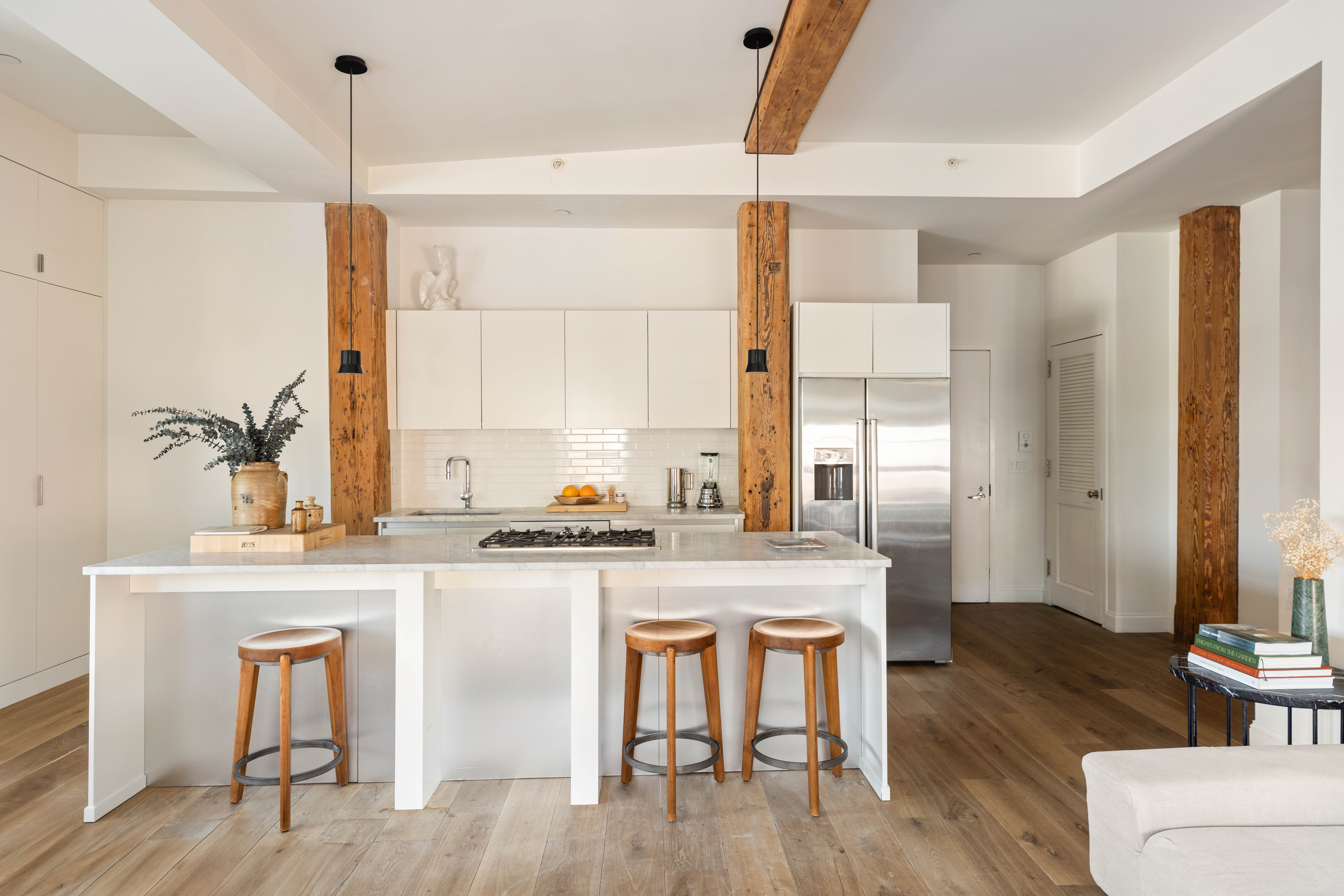 a kitchen with granite countertop wooden floors and white cabinets