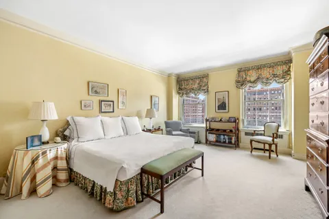 a spacious bedroom with a bed and a couch