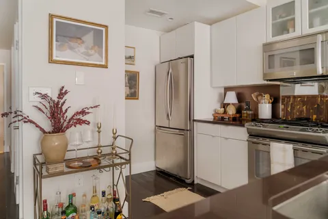 a kitchen with stainless steel appliances a refrigerator a stove a microwave and cabinets