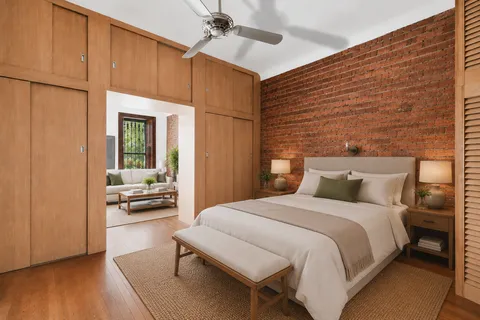 a bedroom with a bed a table and painting on the wall