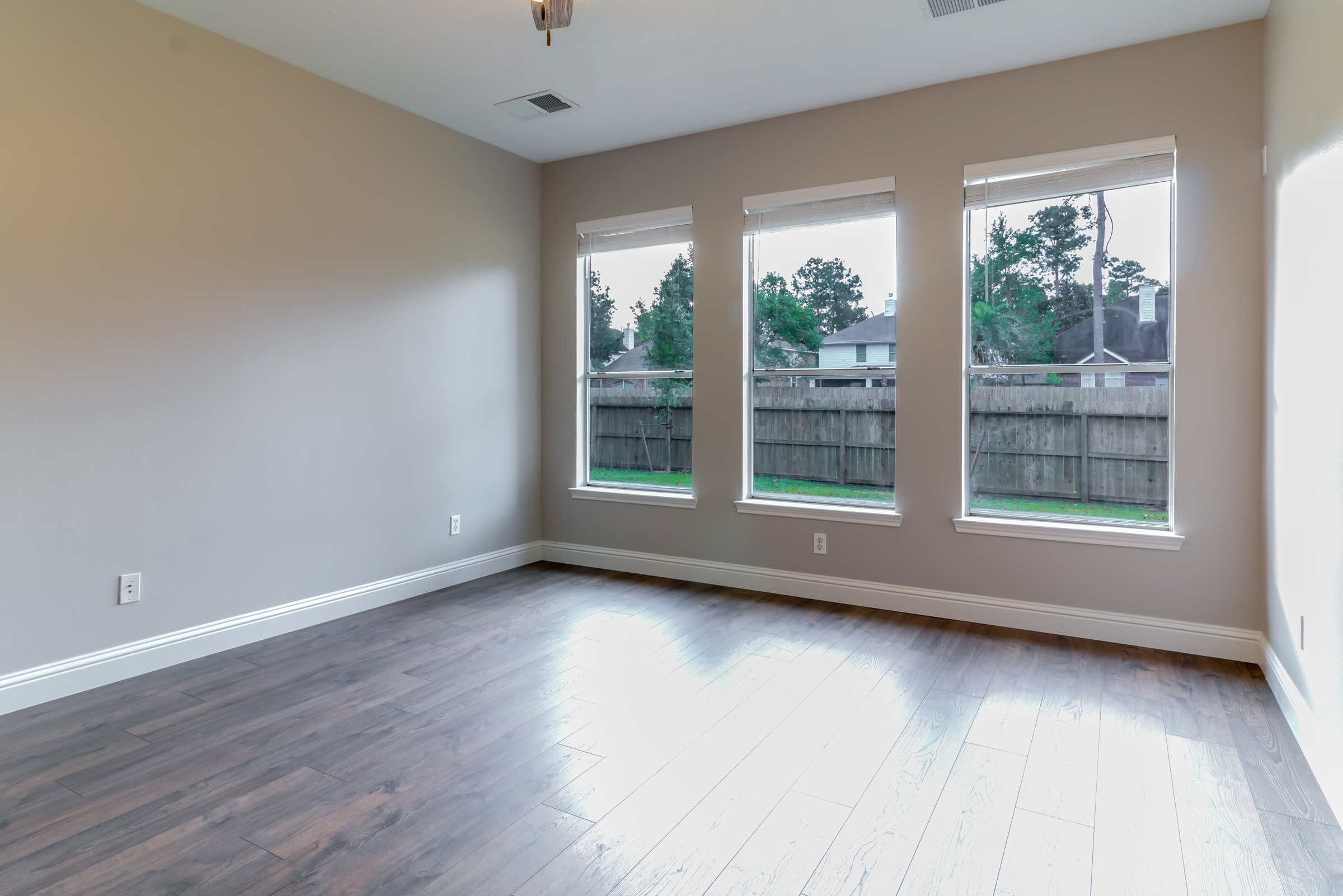 46 Wimberly Way Conroe, TX 77385 - Photo 6 of 16 a view of an empty room with wooden floor and a window