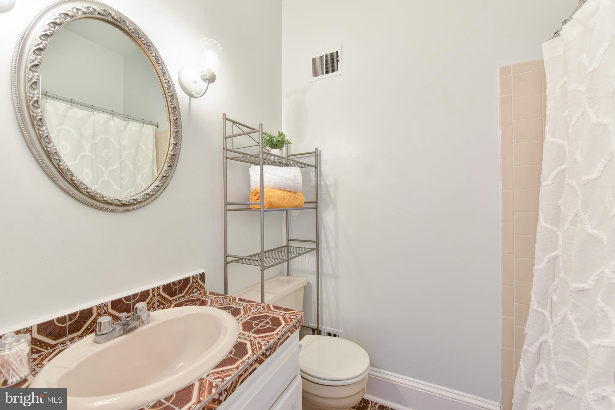 629 5th Street Northeast Washington, DC 20002 - Photo 22 of 31 a bathroom with a sink a toilet and a mirror