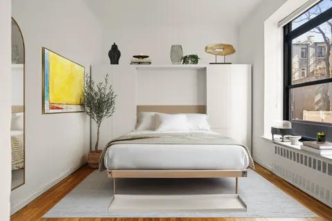 a bedroom with a bed and a window