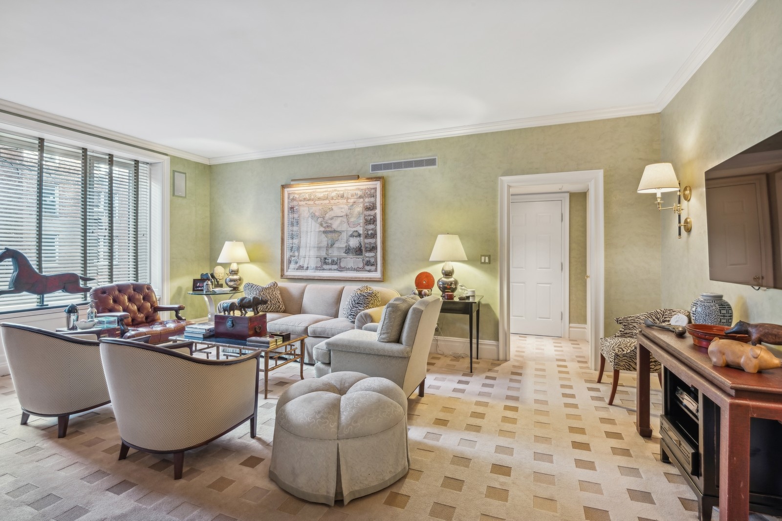a living room with furniture and a potted plant